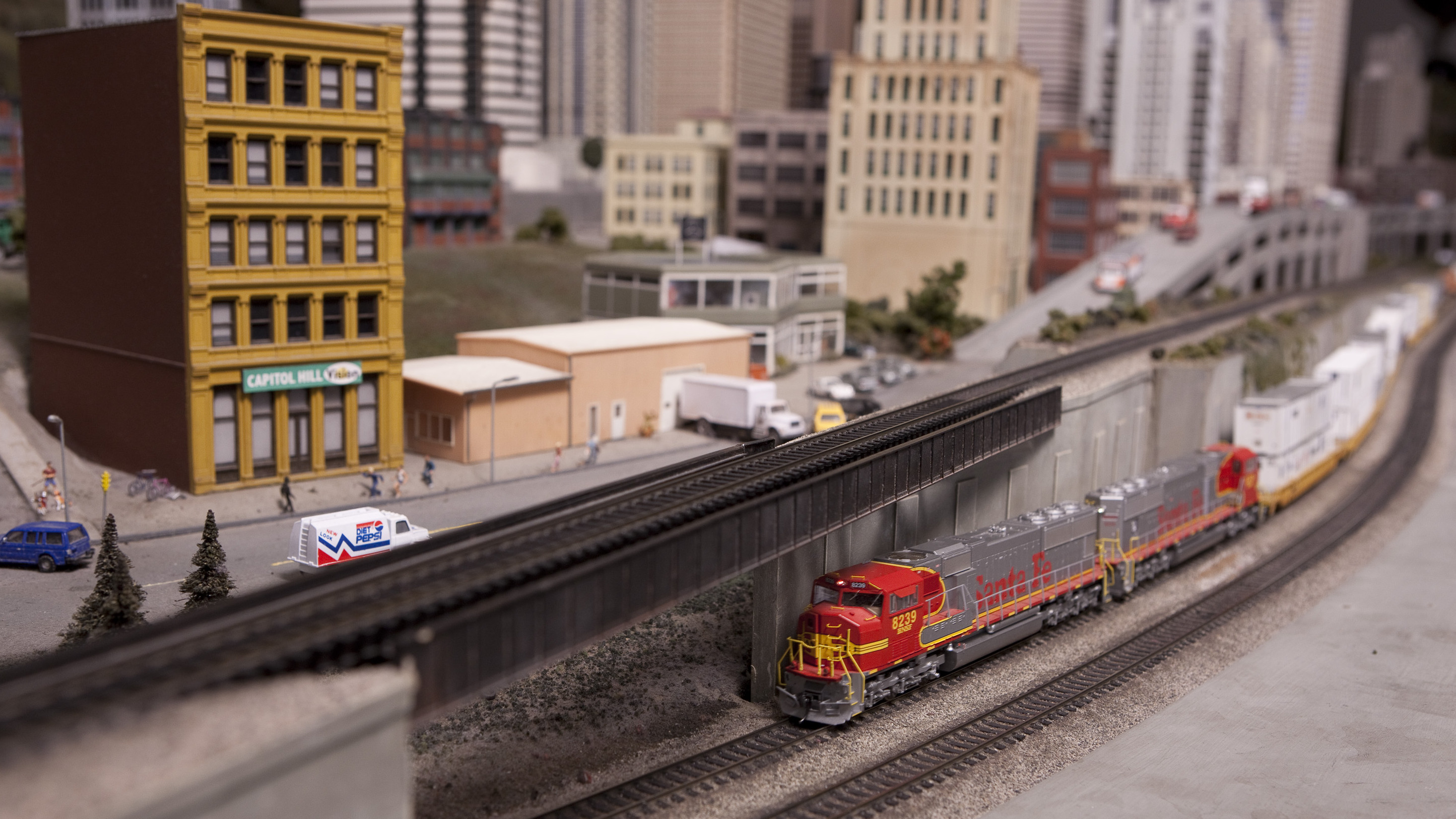 A freight train runs on a lowered track at The Great Train Story. 